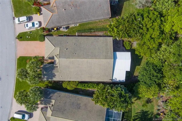an aerial view of a house with garden space and street view