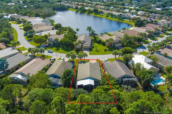an aerial view of a house with a swimming pool and outdoor seating