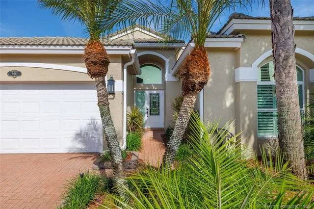 a front view of a house with plants