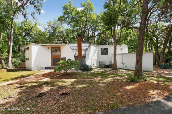 a living room with furniture a fireplace and a chandelier