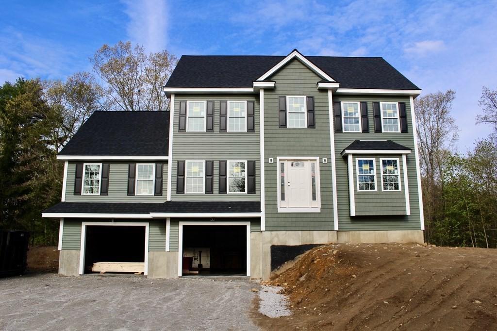 26 Arcadia Road Billerica, MA 01821 - Photo 1 of 4 a front view of a house with a yard and garage