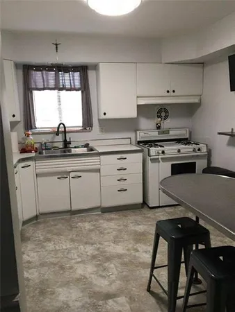 a kitchen with a sink appliances and cabinets