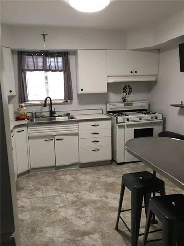 a kitchen with a sink appliances and cabinets