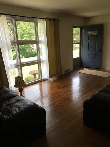 a view of a room with window and wooden floor