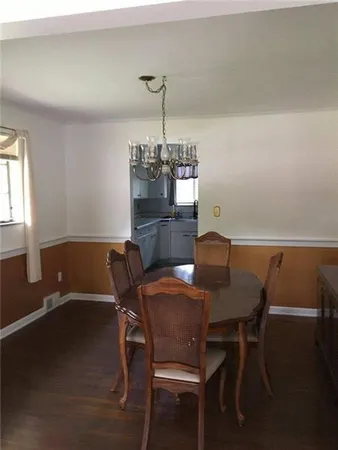 a view of a dining room with furniture and chandelier