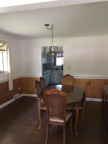 a view of a dining room with furniture and chandelier