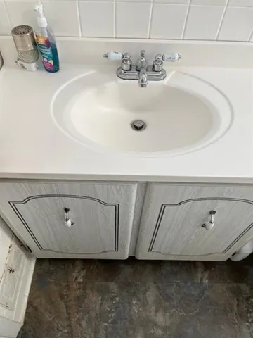 a bathroom with a sink and vanity