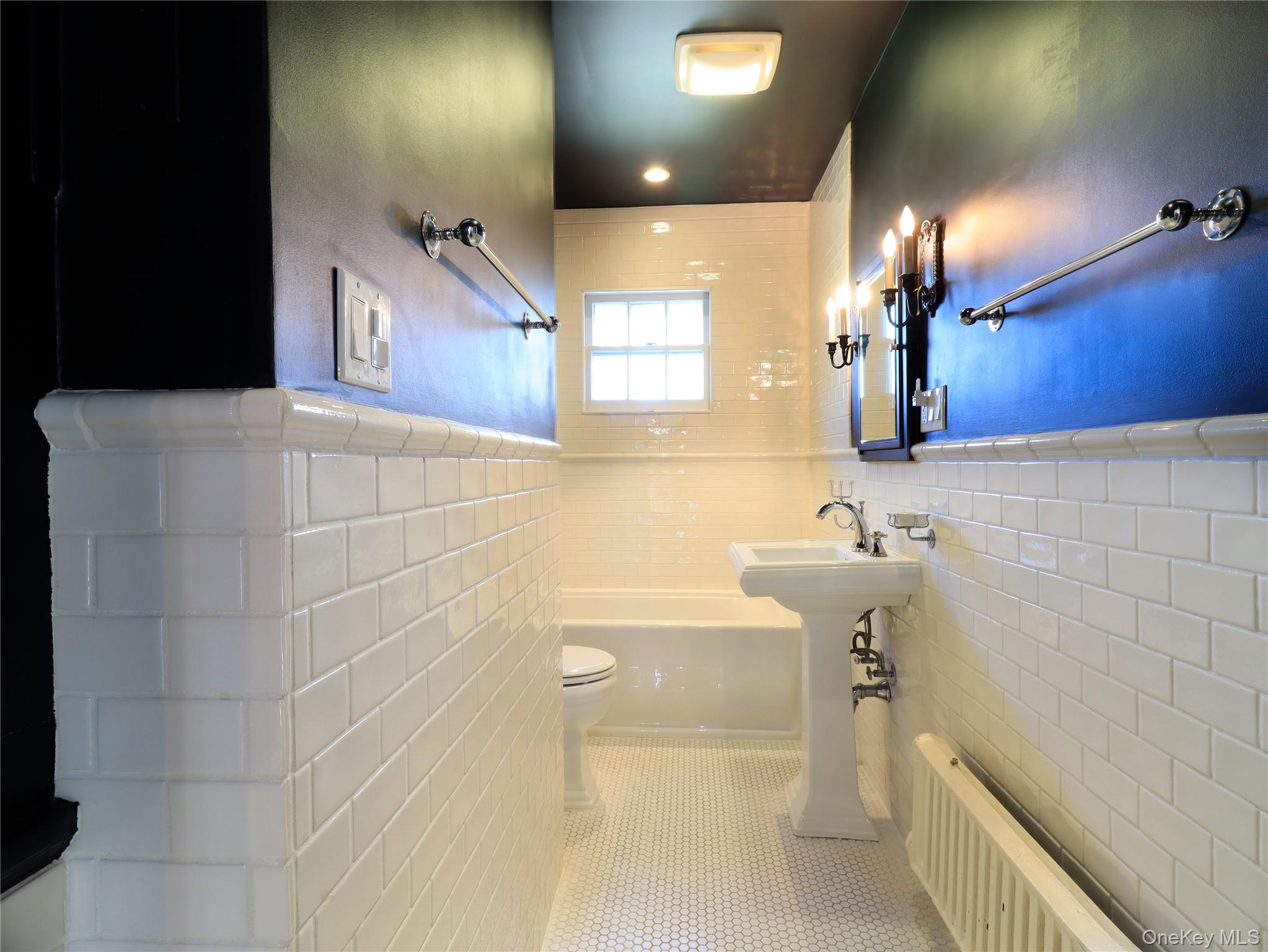 11-20 Shore Road Queens, NY 11363 - Photo 34 of 45 Bathroom featuring white subway tile wainscoting, white hexagon tile flooring, a pedestal sink, and a window