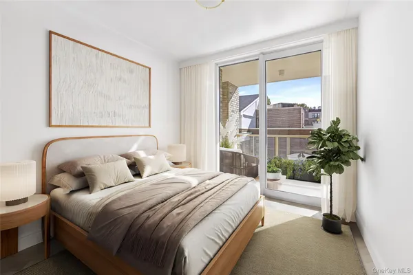 a bedroom with a bed and a potted plant