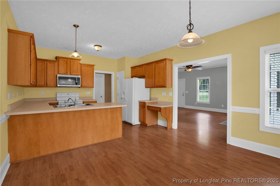 121 Shell Drive Elizabethtown, NC 28337 - Photo 11 of 36 a kitchen with stainless steel appliances granite countertop a refrigerator a sink dishwasher a stove and a wooden floor