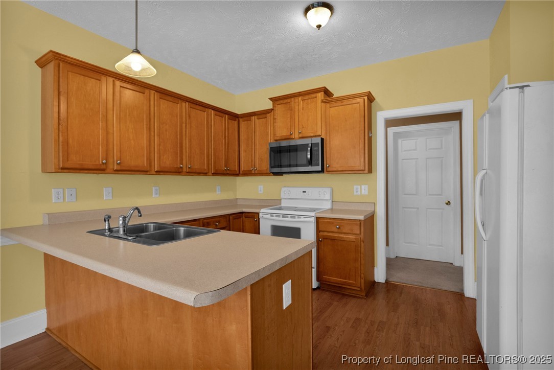 121 Shell Drive Elizabethtown, NC 28337 - Photo 15 of 36 a kitchen with stainless steel appliances a stove a sink a microwave a refrigerator and cabinets