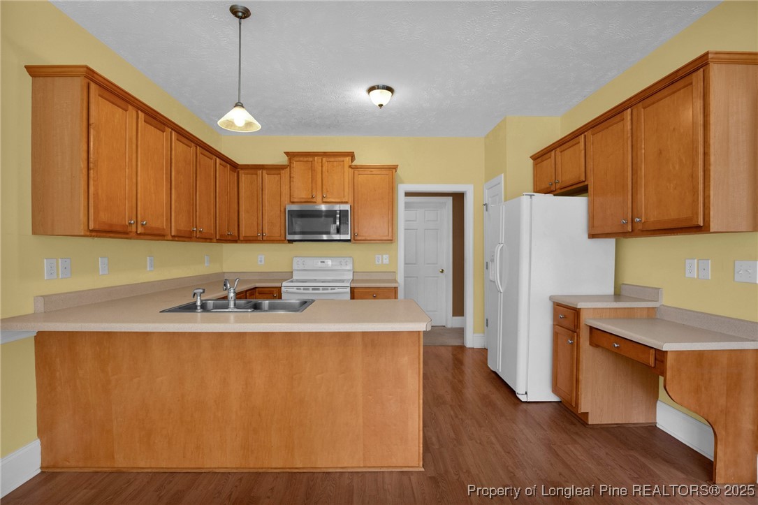121 Shell Drive Elizabethtown, NC 28337 - Photo 16 of 36 a kitchen with stainless steel appliances granite countertop a sink a refrigerator a stove a washer and dryer with wooden floor