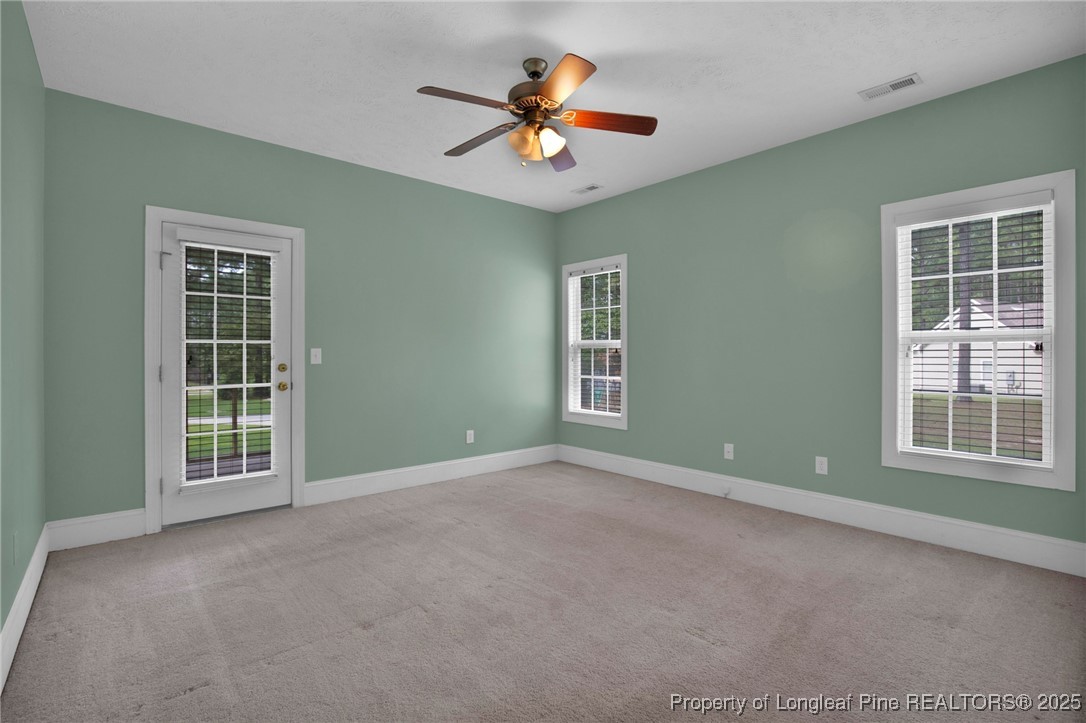 121 Shell Drive Elizabethtown, NC 28337 - Photo 19 of 36 an empty room with windows and ceiling fan