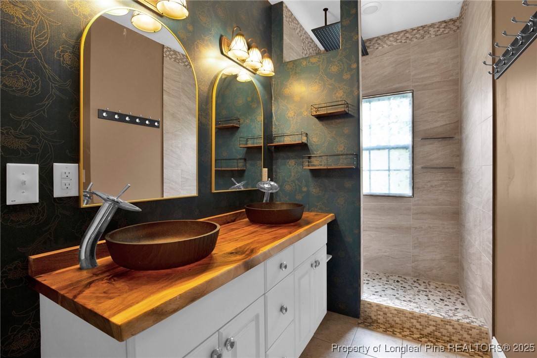 121 Shell Drive Elizabethtown, NC 28337 - Photo 24 of 36 a bathroom with a sink a mirror and a shower