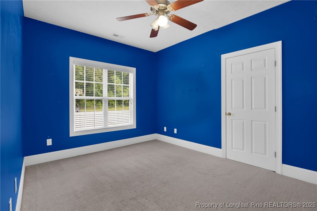 121 Shell Drive Elizabethtown, NC 28337 - Photo 29 of 36 an empty room with windows and fan