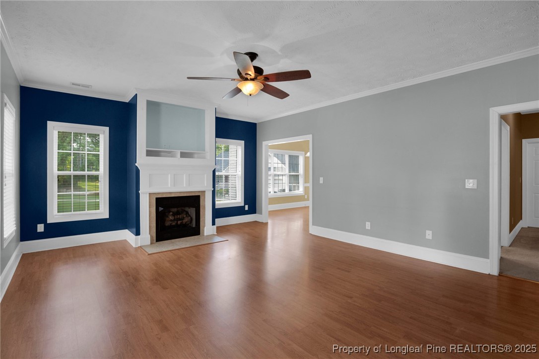121 Shell Drive Elizabethtown, NC 28337 - Photo 7 of 36 a view of a livingroom with a fireplace a ceiling fan and windows