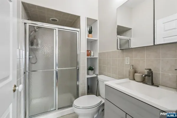 a bathroom with a shower a toilet and a sink