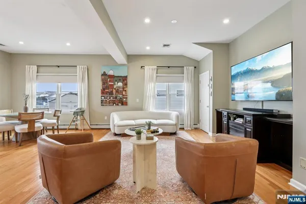 a living room with fireplace furniture and floor to ceiling windows