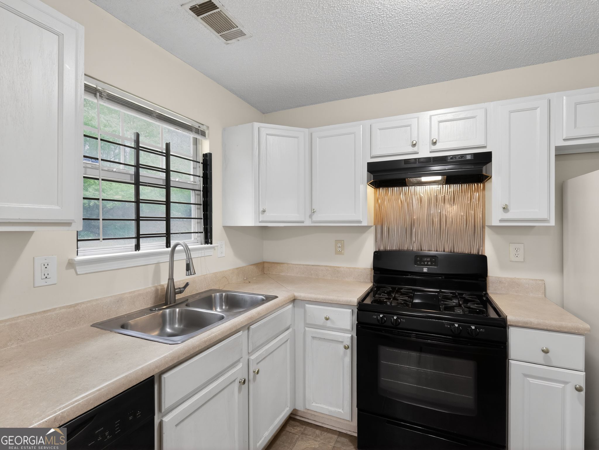 4460 Abram Way Conley, GA 30288 - Photo 6 of 29 a kitchen with a sink stove top oven and cabinets