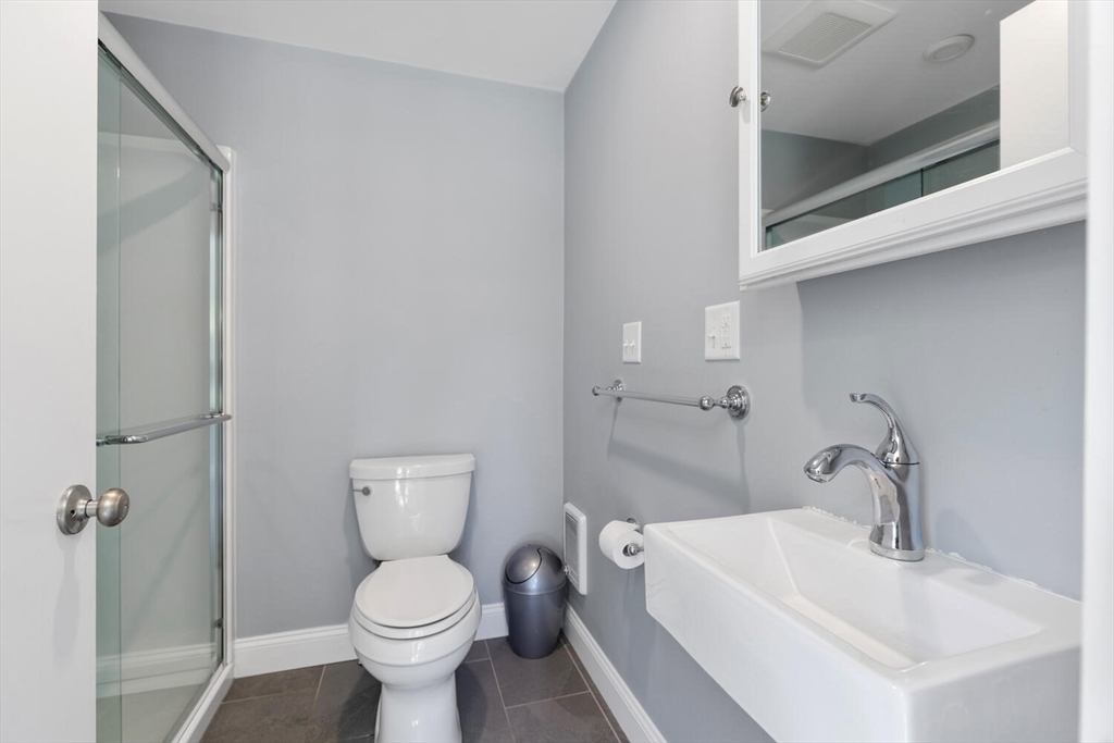 20 Marion Road Watertown, MA 02472 - Photo 11 of 33 a bathroom with a toilet sink and mirror