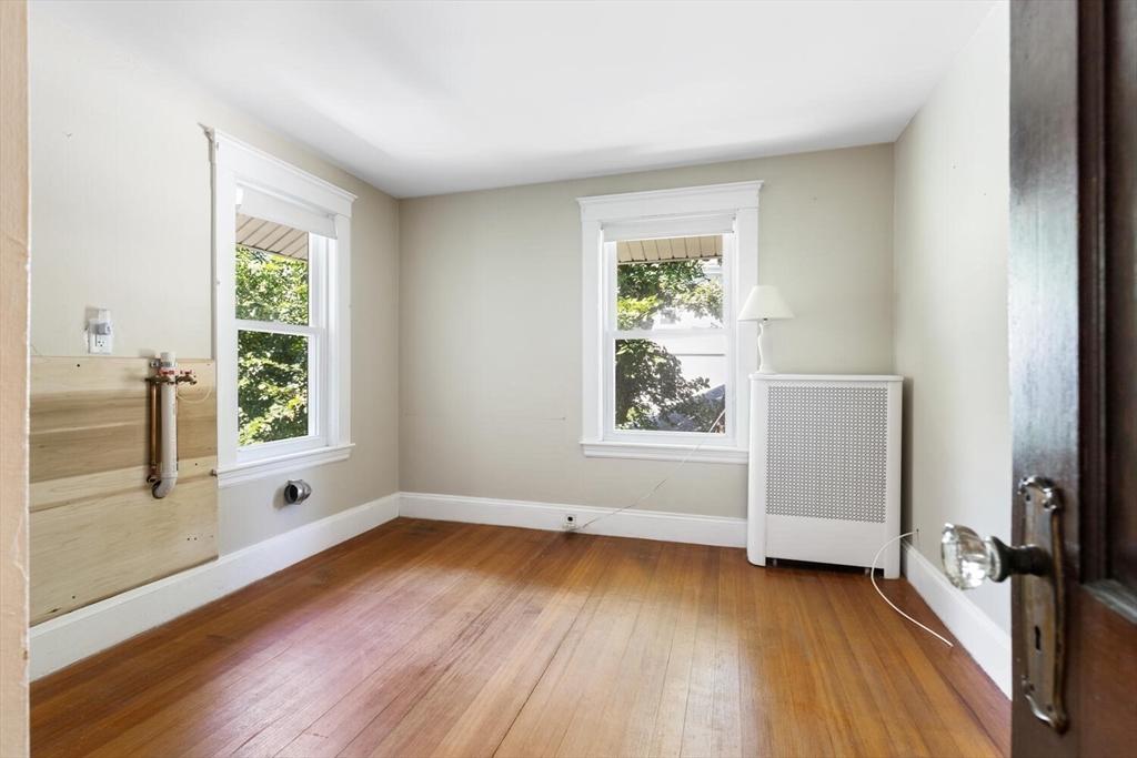 20 Marion Road Watertown, MA 02472 - Photo 20 of 33 a view of an empty room with wooden floor and a window