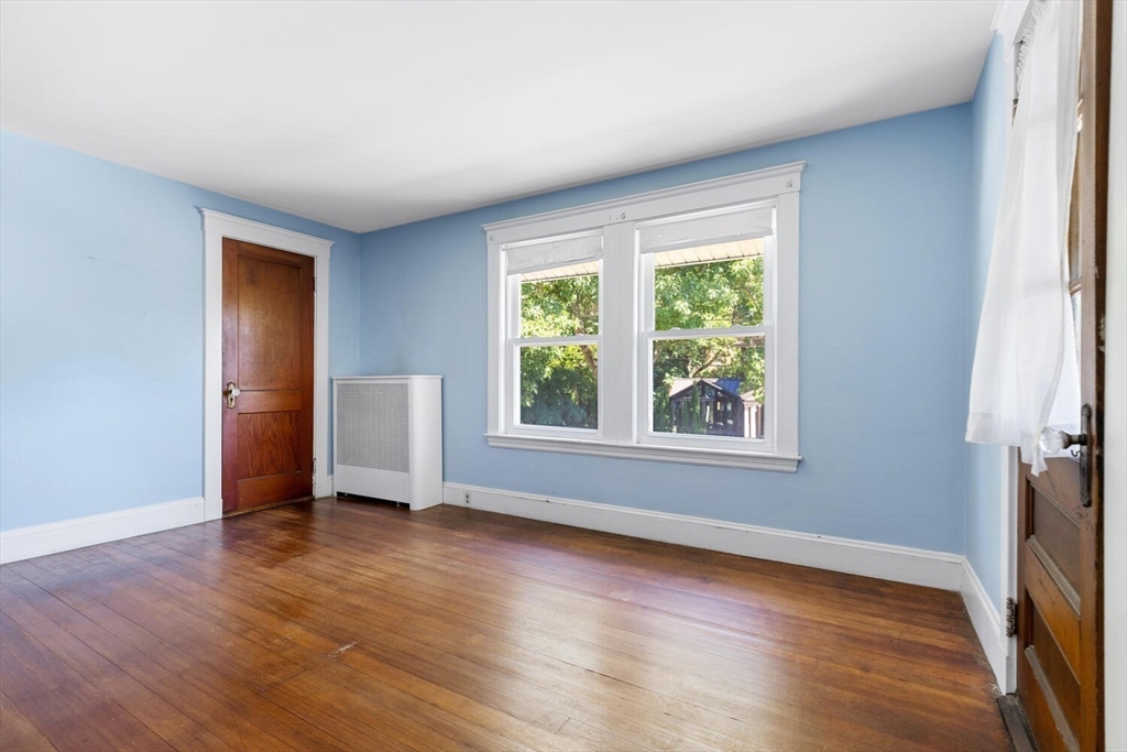 20 Marion Road Watertown, MA 02472 - Photo 24 of 33 an empty room with wooden floor and windows