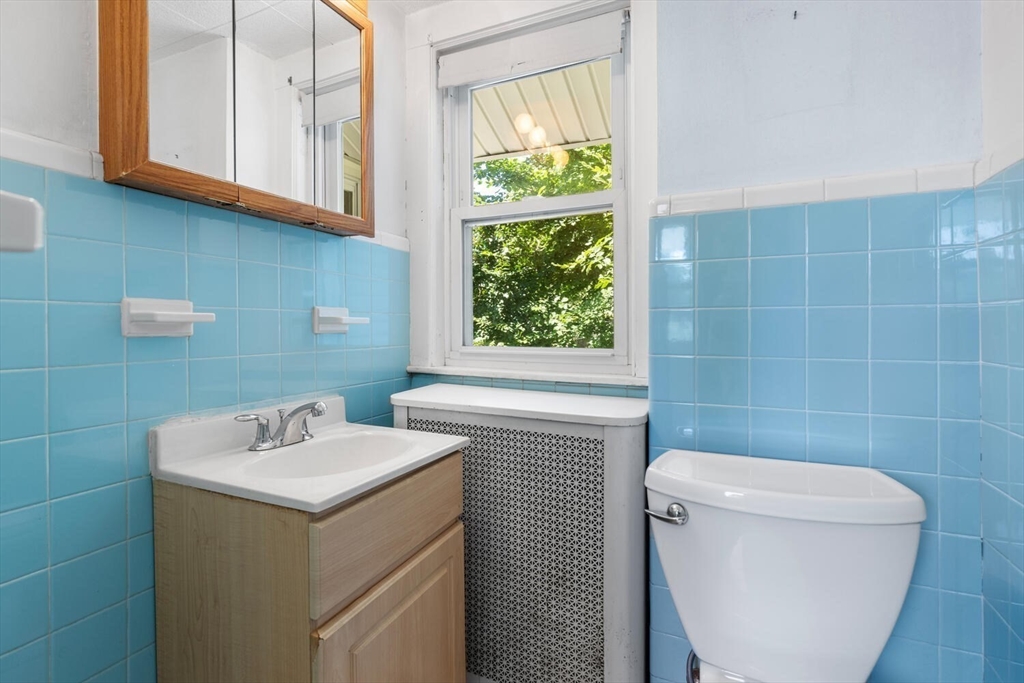 20 Marion Road Watertown, MA 02472 - Photo 27 of 33 a bathroom with a sink a toilet and a mirror