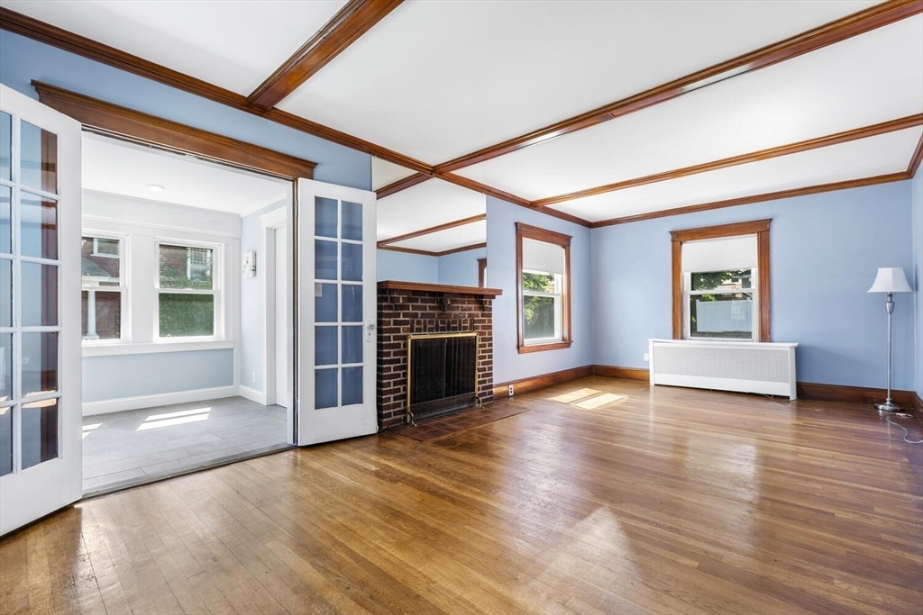 20 Marion Road Watertown, MA 02472 - Photo 7 of 33 a view of an empty room with wooden floor fireplace and a window