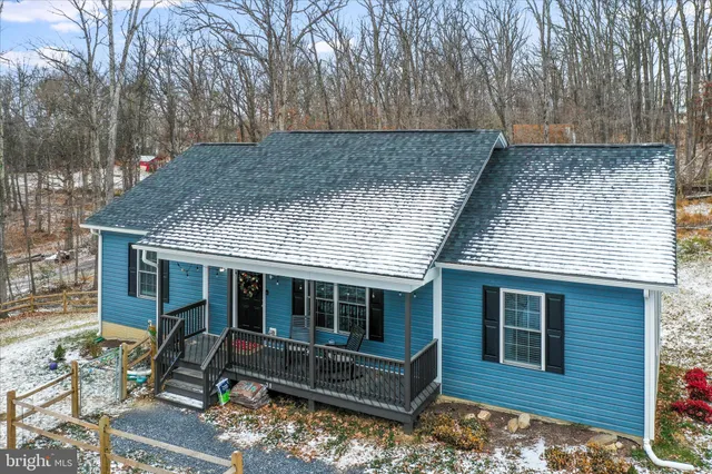 a front view of house with a garden