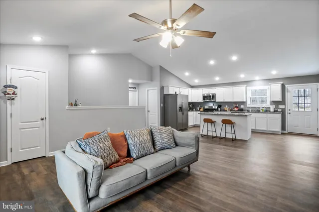 a living room with furniture and kitchen view