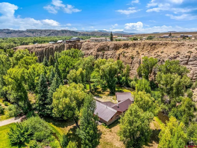 an aerial view of a house with a yard