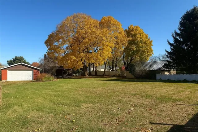 a view of a field with an trees in the background