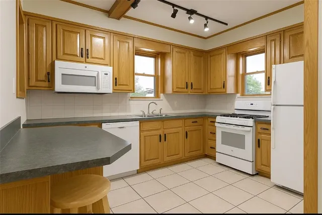 a kitchen with granite countertop cabinets stainless steel appliances a sink and a window