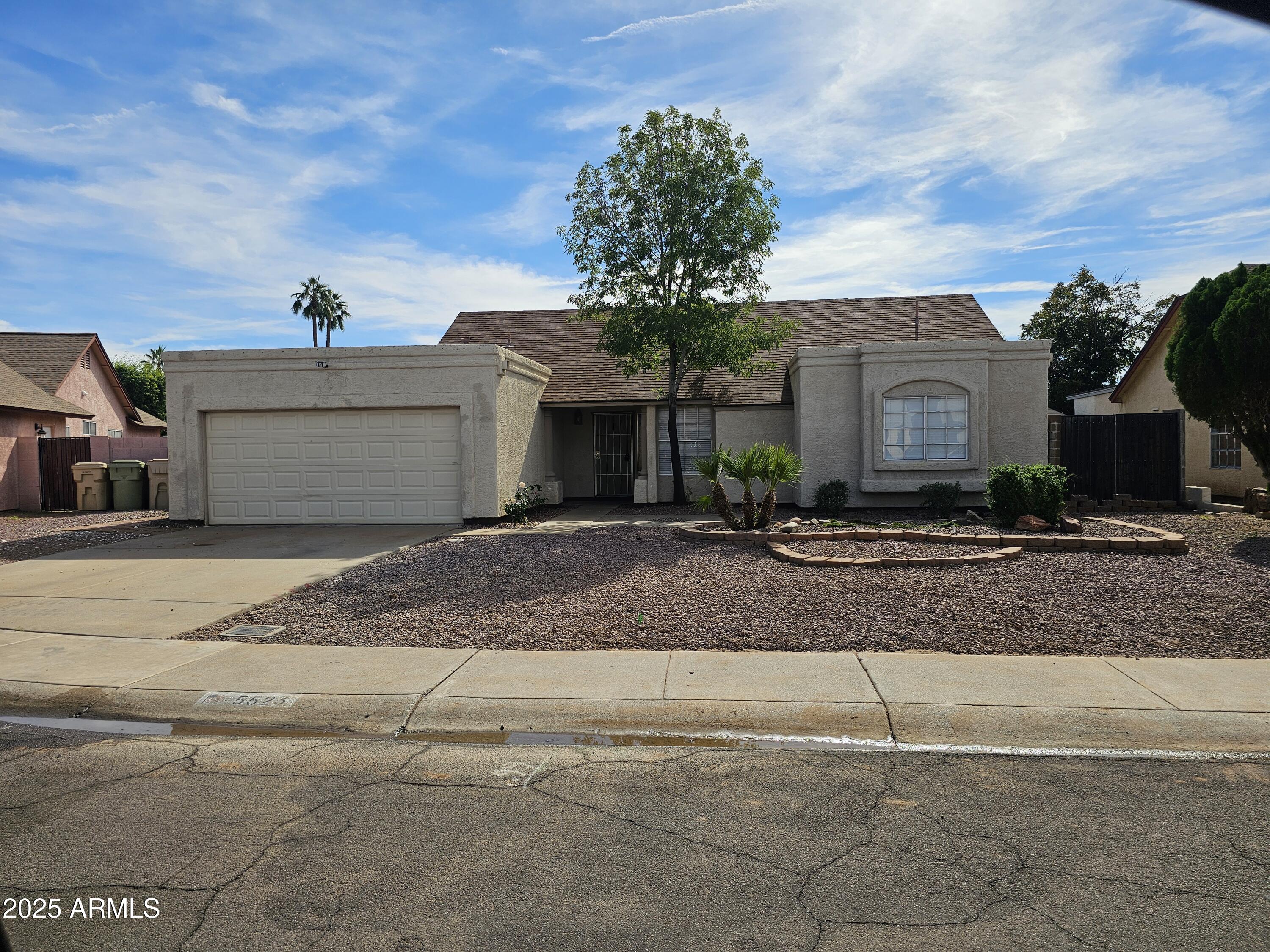 5523 West Yucca Street Glendale, AZ 85304 - Photo 1 of 18 a front view of a house with a yard and garage