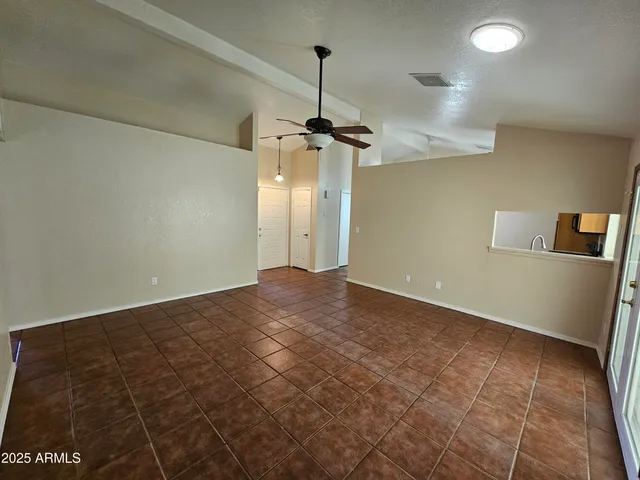 a view of a room with a ceiling fan
