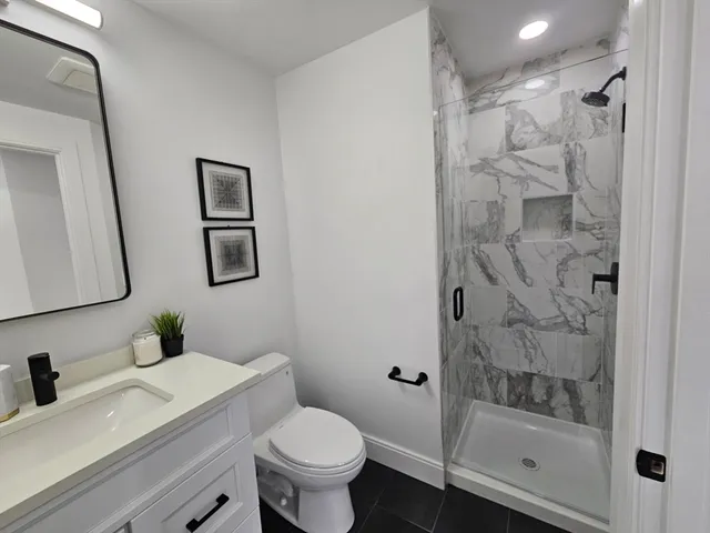 a bathroom with a sink toilet and shower
