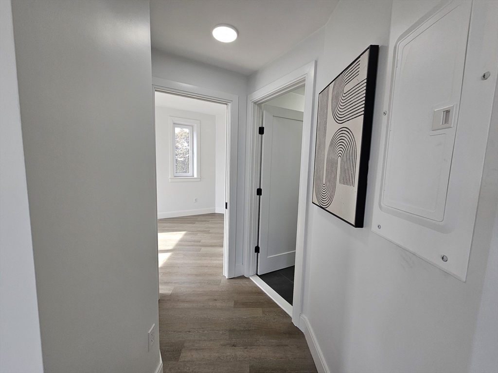 64 Alpine Street, Unit 304 Boston, MA 02119 - Photo 18 of 23 a view of a hallway with wooden floor