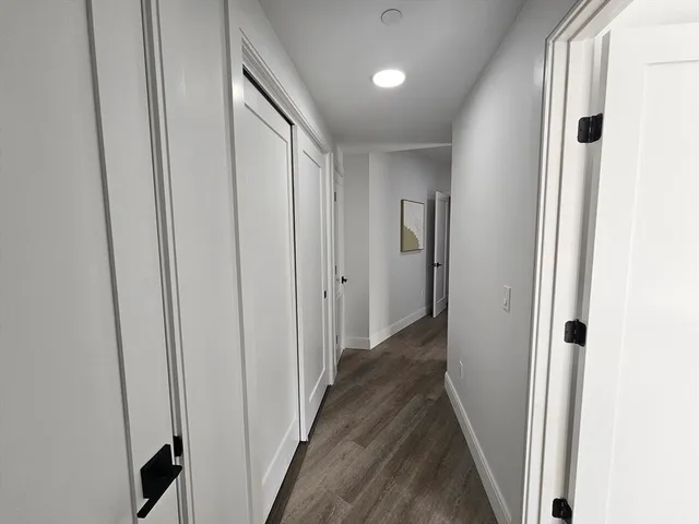 a view of a hallway with wooden floor