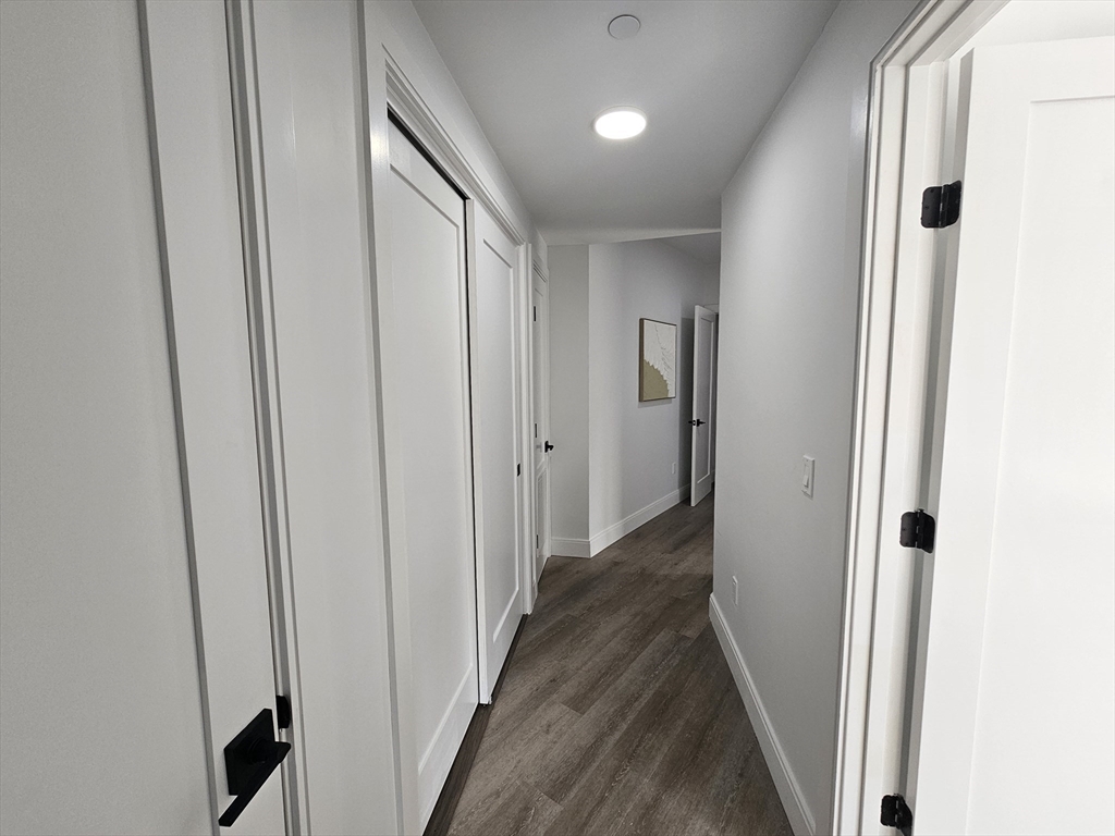 64 Alpine Street, Unit 304 Boston, MA 02119 - Photo 19 of 23 a view of a hallway with wooden floor