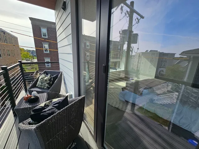 a view of a balcony with chairs