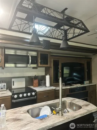 a kitchen with a stove and a microwave