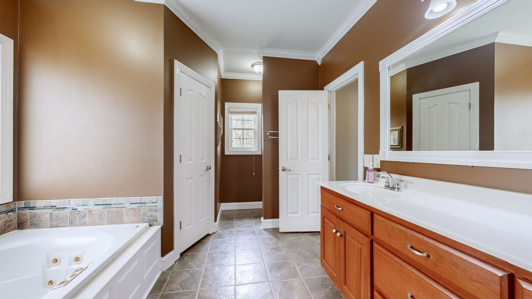 3664 Whippoorwill Road Lebanon, TN 37090 - Photo 55 of 69 a bathroom with a tub sink and mirror