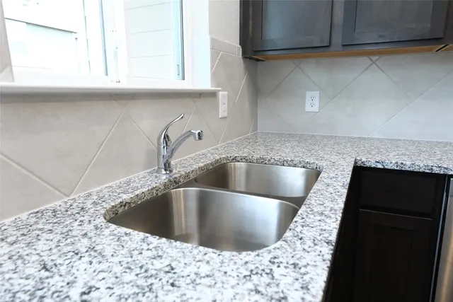 a kitchen with a sink and cabinets