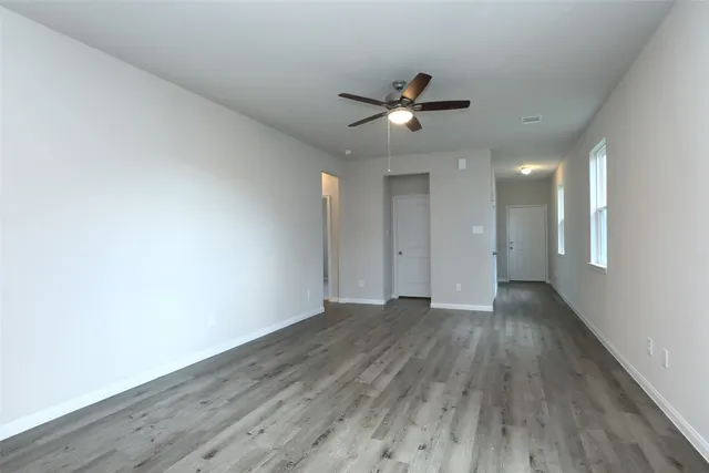 a view of an empty room and wooden floor