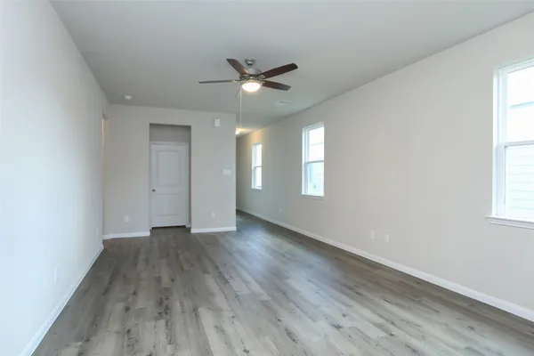 a view of an empty room and wooden floor