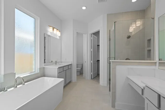 a bathroom with a tub sink and mirror