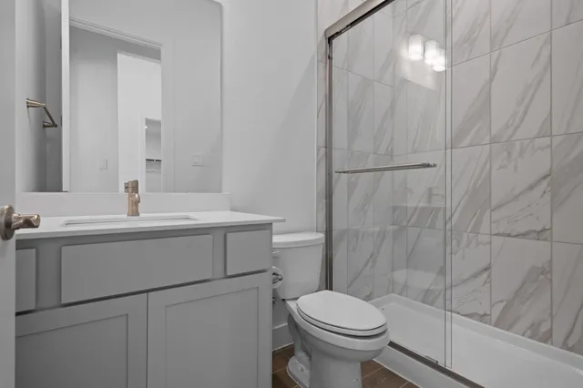 a bathroom with a sink toilet and shower