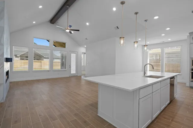 an open kitchen with a sink and a refrigerator