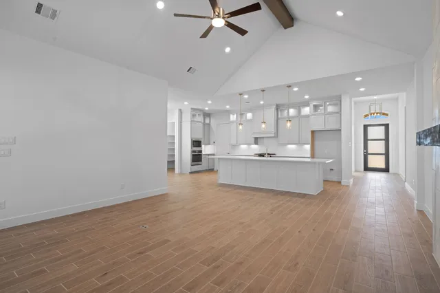 a view of a kitchen with a dishwasher and wooden floor