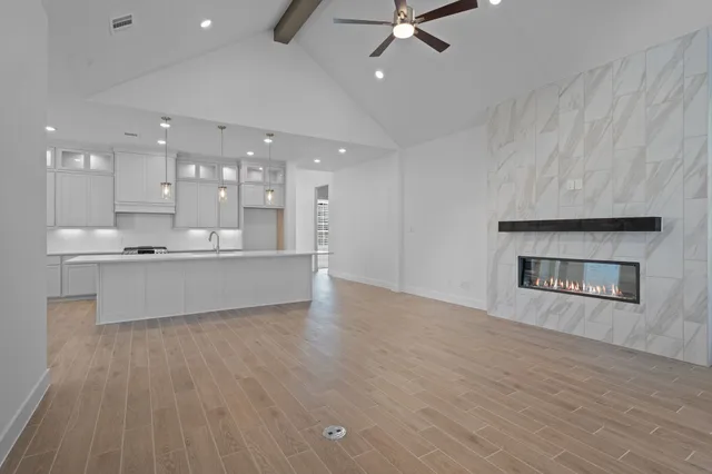 a large kitchen with cabinets and a fireplace